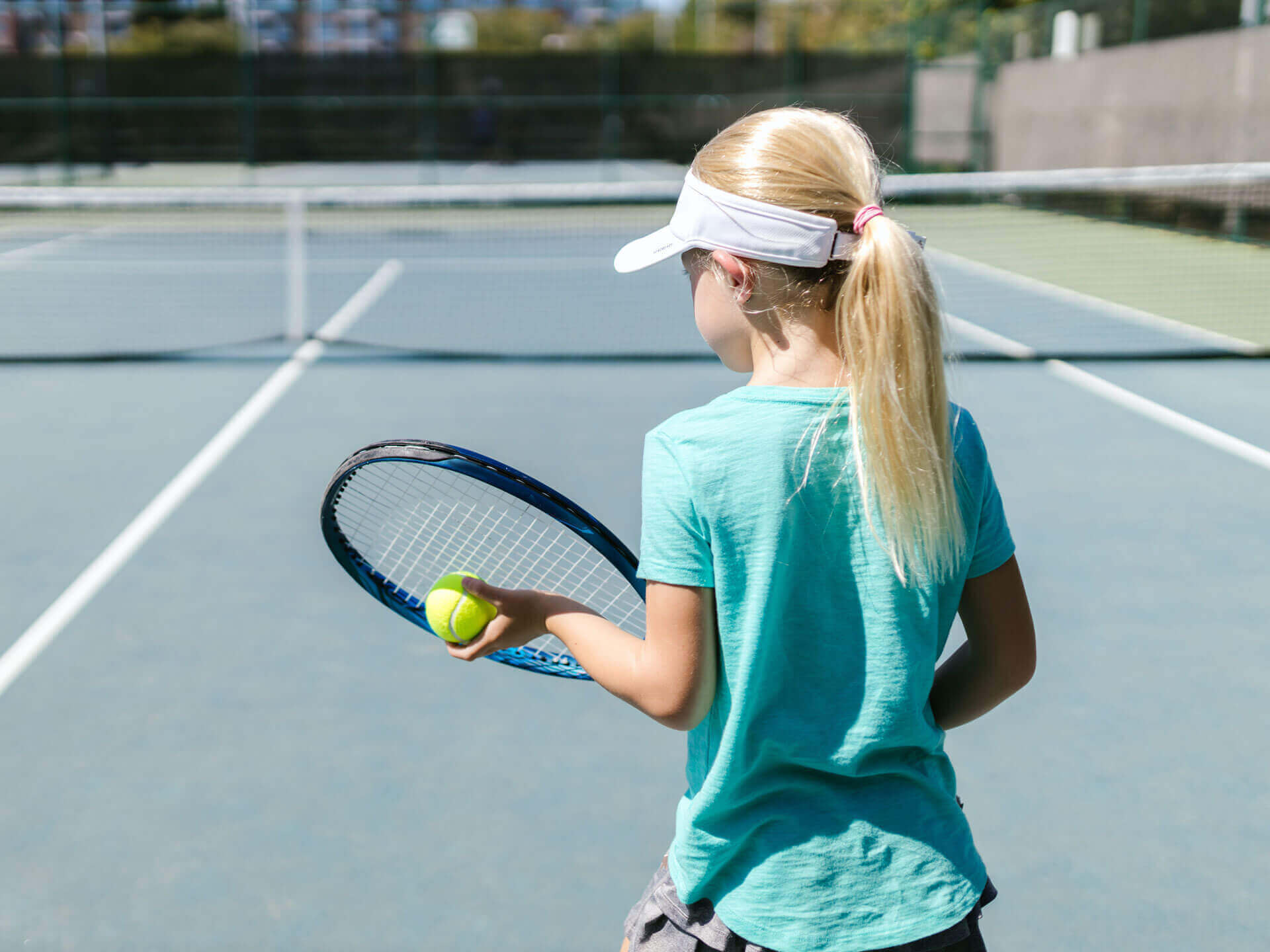 Young girl playing tennis