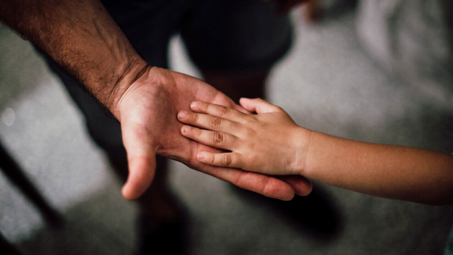 Young child's hand in an adults hand