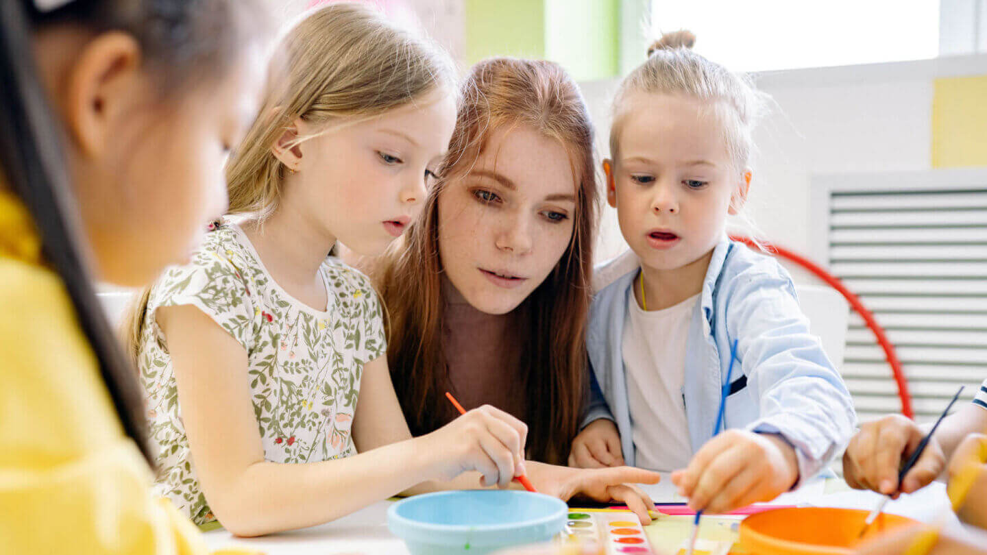 Kindergarten teacher with children